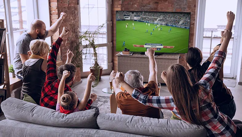 family watching a soccer match on TV