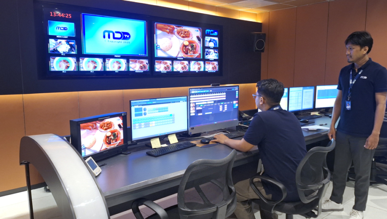 two people working in a broadcast control room