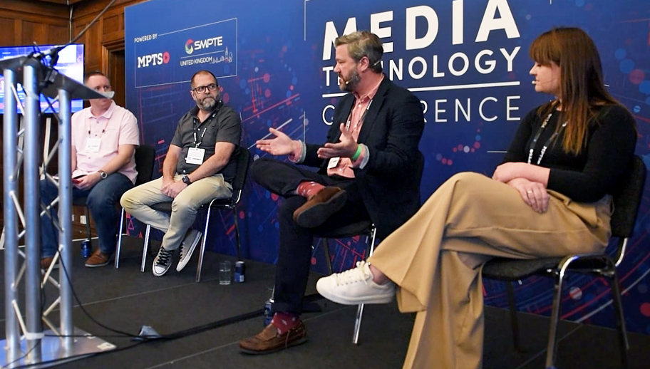 a group of panelists sitting on stage giving a talk