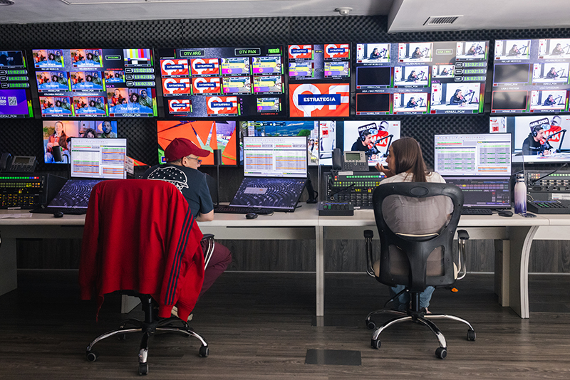 broadcast operators in front of a large multiviewer wall
