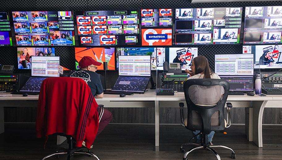 broadcast operators in front of a large multiviewer wall